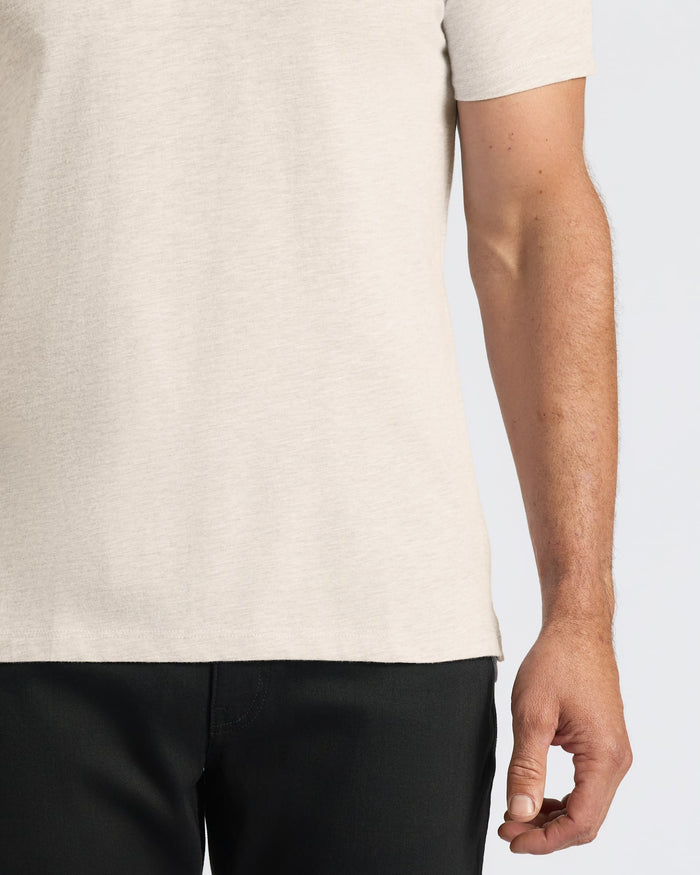 Oatmeal Classic Polo on person’s midsection with arm visible.