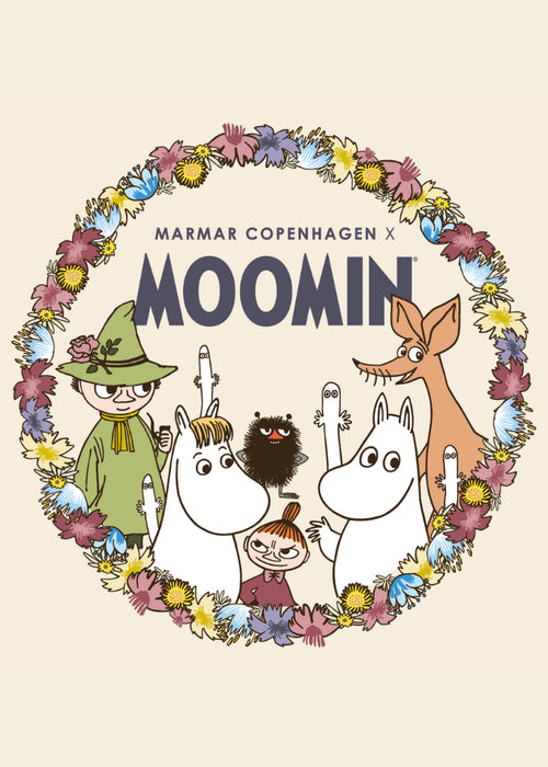 Moomin-tryk med blomsterkrans og figurer foran på blusen