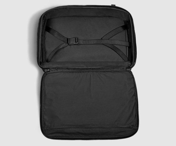 Open, unpacked backpack showing the compression straps