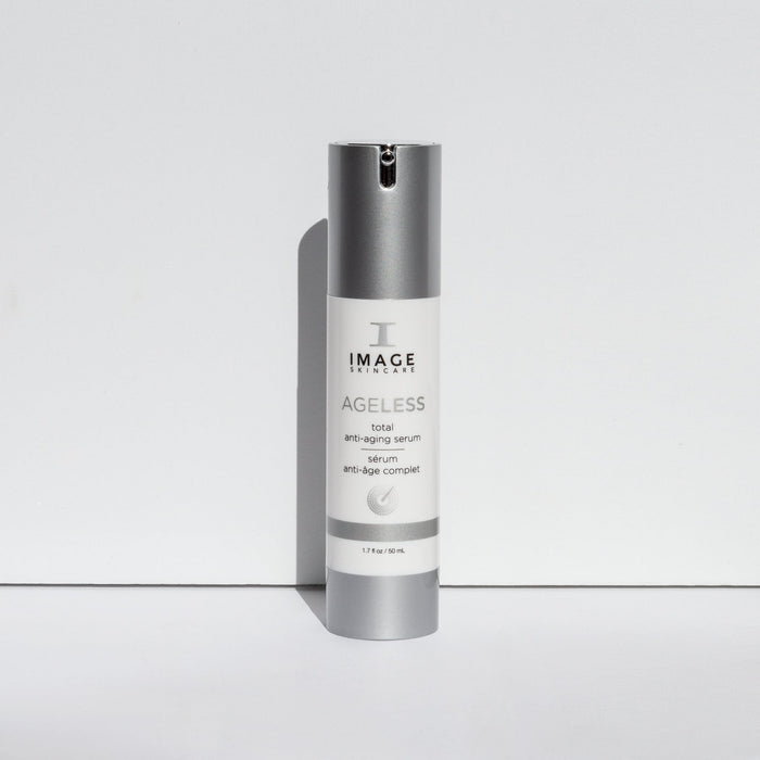 Bottle of AGELESS total anti-aging serum | IMAGE Skincare standing upright with a silver cap and white label on a plain white background, showcasing skincare product design.