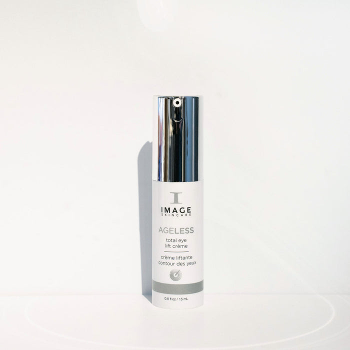 Bottle of AGELESS total eye lift crème | IMAGE Skincare with a silver pump dispenser against a clean white background, highlighting premium skincare for the eye area.