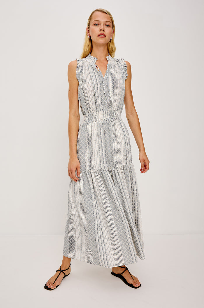Alessi Maxi Dress in Linen With Smocked Split V-Neckline With Center-Front Ties Diamond Eyelet Detailing All Over Ruffled Trim and Fully Lined Tiered Skirt in Striped Eyelet Colorway - Full Body Front View Featured on Model