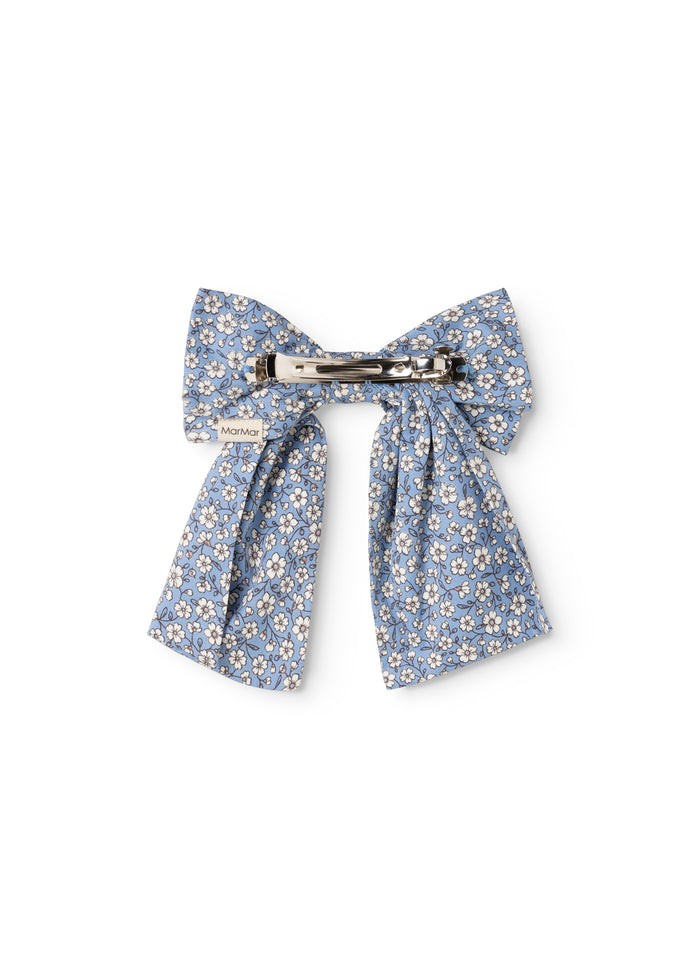 Blue hair clip with large flower bow and metal clasp.