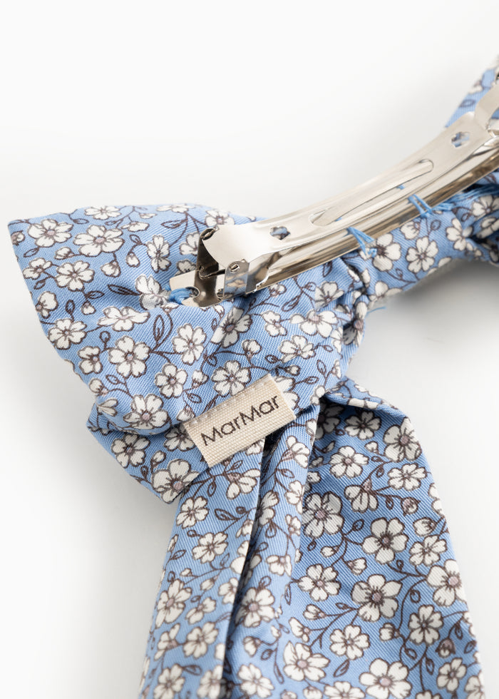Blue hairband with metal clips and "MarMar" branding.