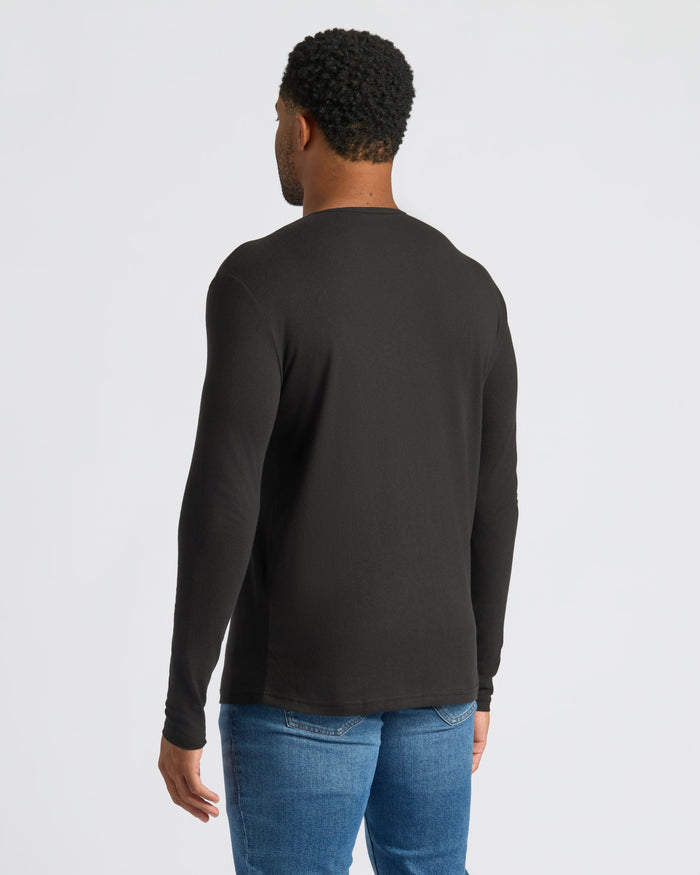 Man in Black Long Sleeve Henley and blue jeans, rear view.
