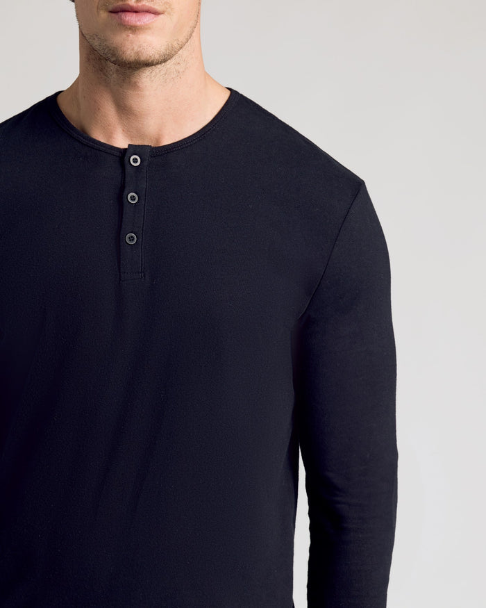 Man wearing All Black Classic Henley, showcasing its premium fitted design.