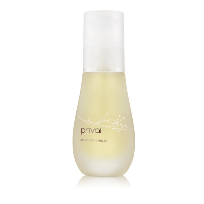 Clear frosted glass bottle with white pump containing light yellow liquid labeled Antioxidant Repair | Privai, a skincare product for antioxidant body care.