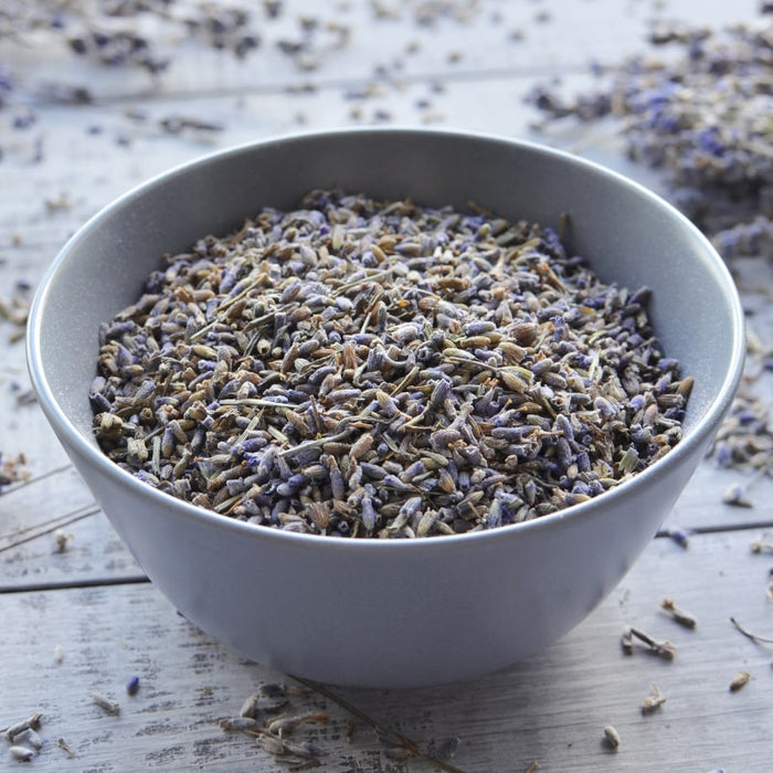 Bowl filled with dried lavender buds on a wooden surface, evoking natural ingredients for skincare and wellness in Antioxidant Repair | Privai products.