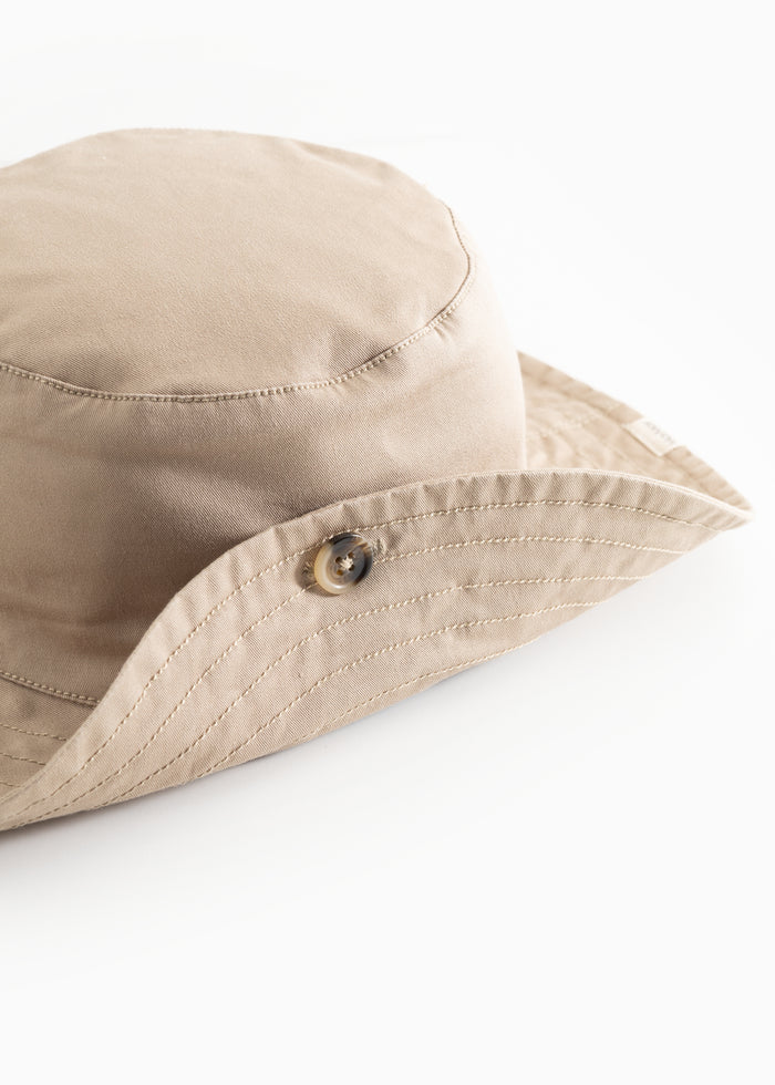 Bright brown cap with a button front and stitching along the brim.