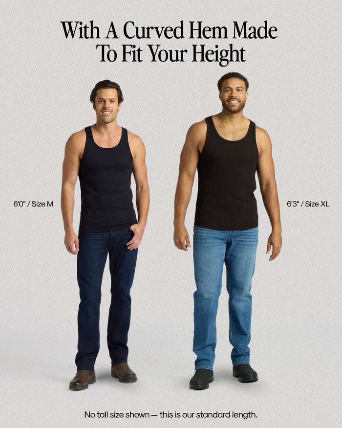 Two men wearing black tank tops and blue jeans with text about a curved hem fit.