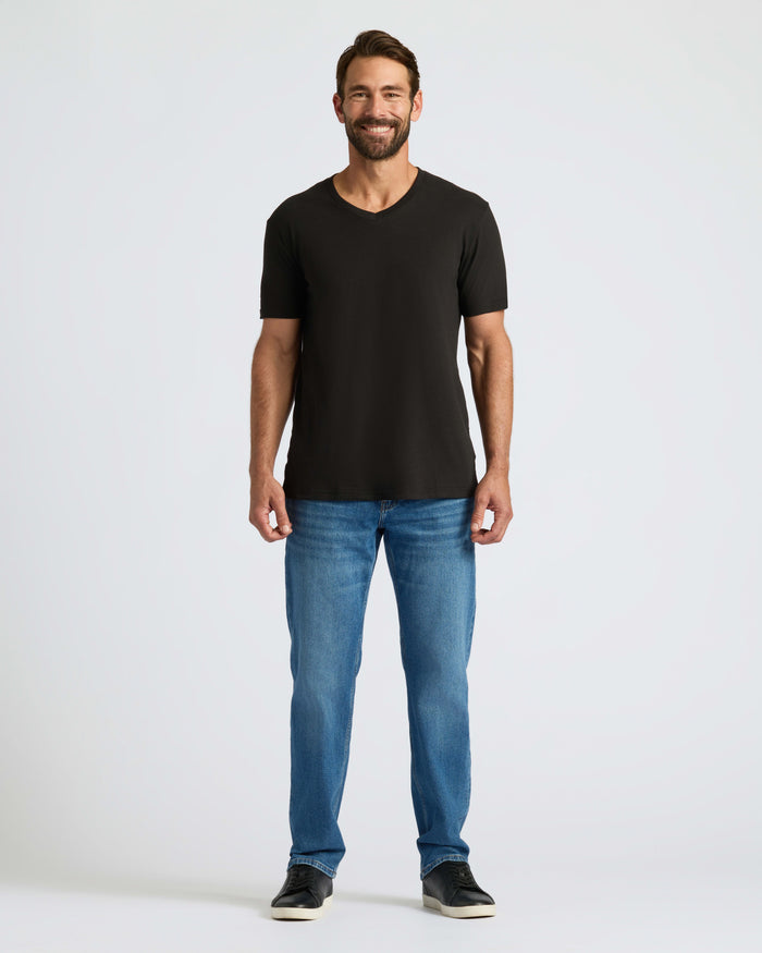 Man wearing Classic V-Neck T-shirt with jeans and sneakers.