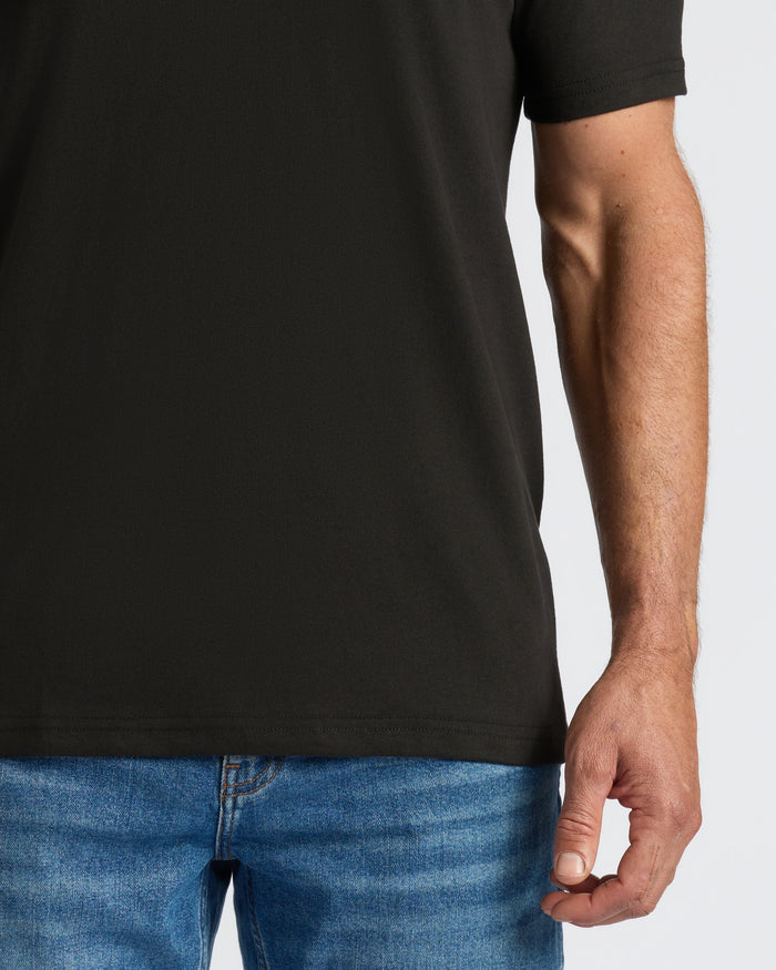 Classic V-Neck T-shirt worn with jeans, showing right arm and hand.