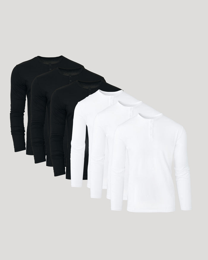 Three black long-sleeve shirts and one white long-sleeve shirt on a light gray background