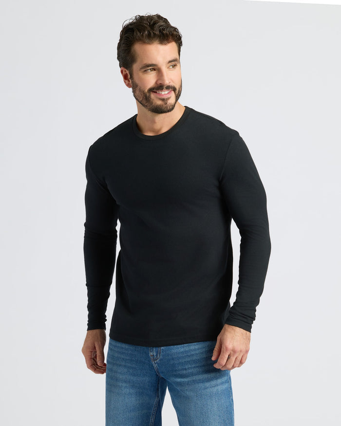 Man wearing Black & White Classic Long Sleeve Crew Neck, smiling.