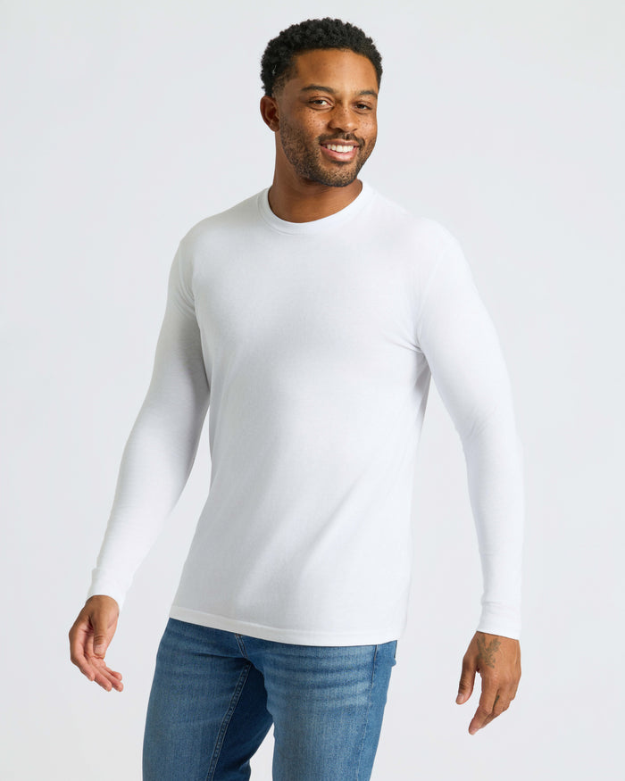 Man wearing Black & White Classic Long Sleeve Crew Neck, smiling, arms relaxed.