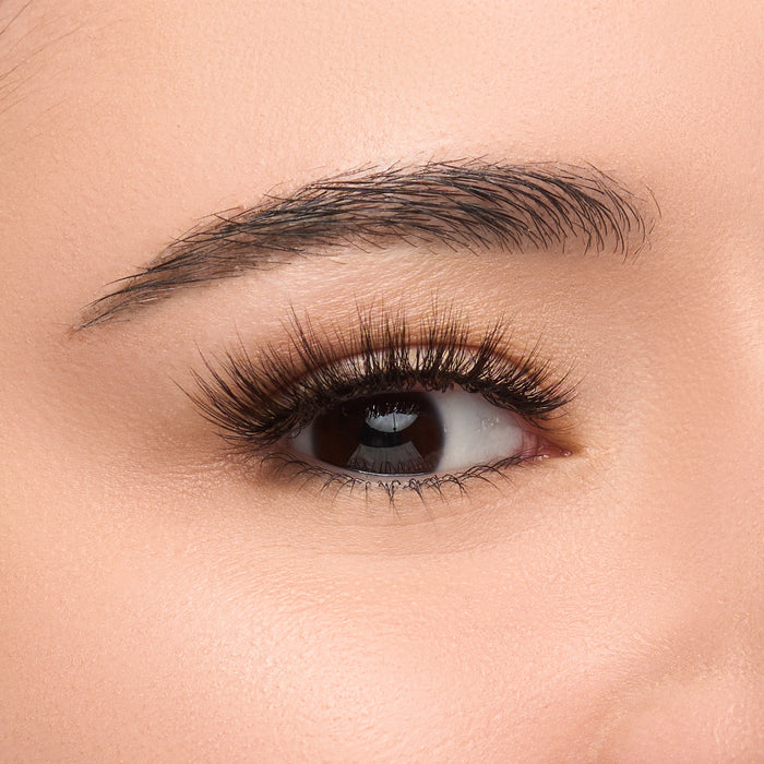 Blessings flared false lash with short, dense fibers at the base and longer, wispy tips shown on an eye.