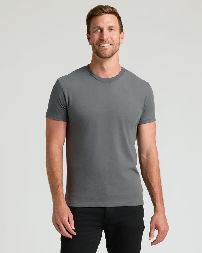 Man wearing Carbon Classic Crew Neck T-shirt and slim-fit black pants.