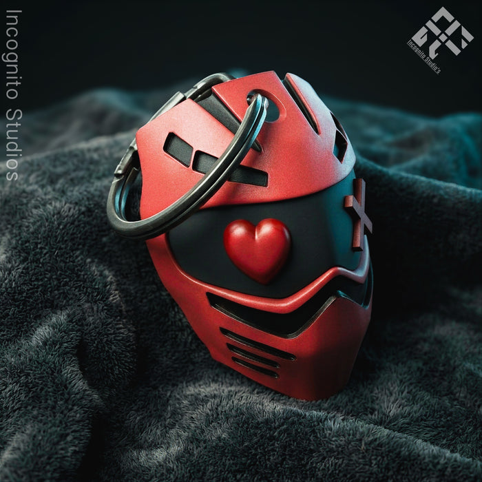 Red and black helmet with a heart emblem on a dark textured surface