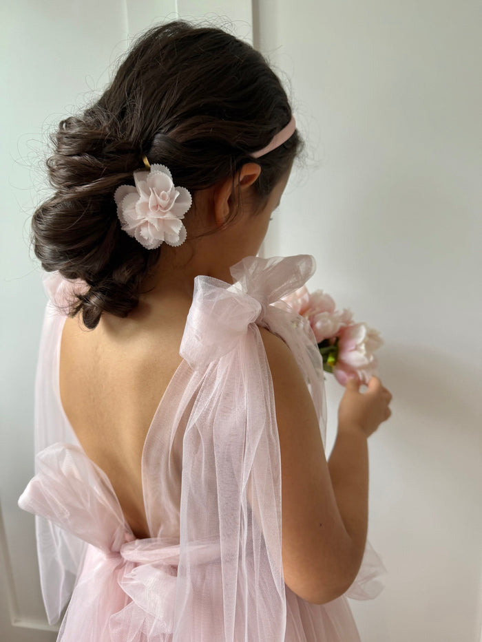 Cherry Blossom white and pink hair clip styled in a low bun, featuring a delicate floral accent for elegant girls hairstyles