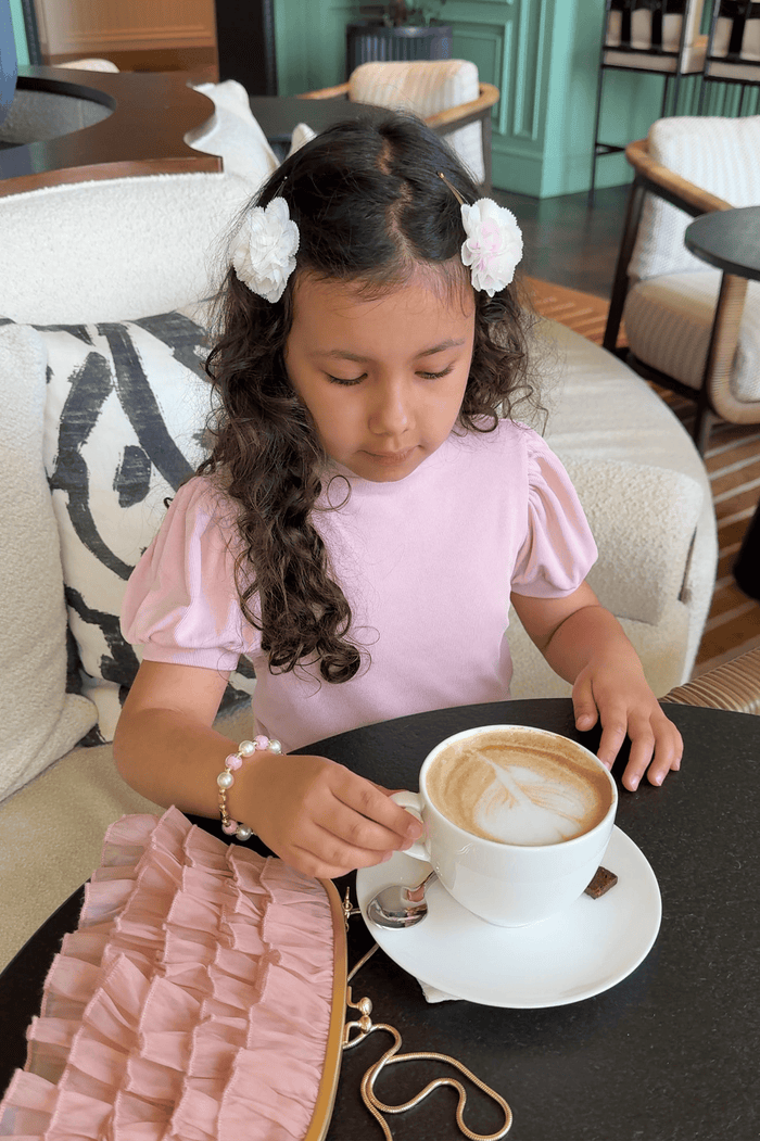 Cherry Blossom white and pink hair clips styled with a casual pink outfit, perfect for everyday wear and special moments