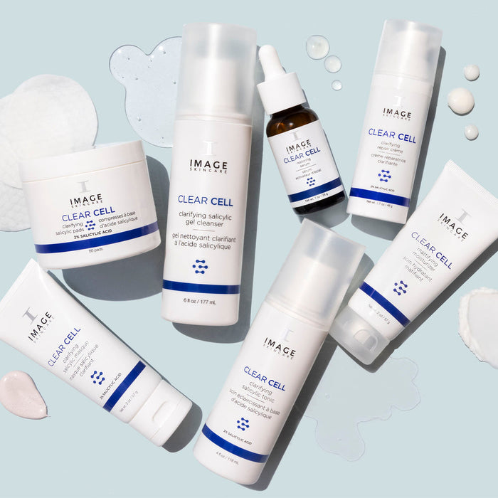 Collection of IMAGE Skincare CLEAR CELL Restoring Serum and related skincare products displayed on a light blue background with clear gel and cream samples.