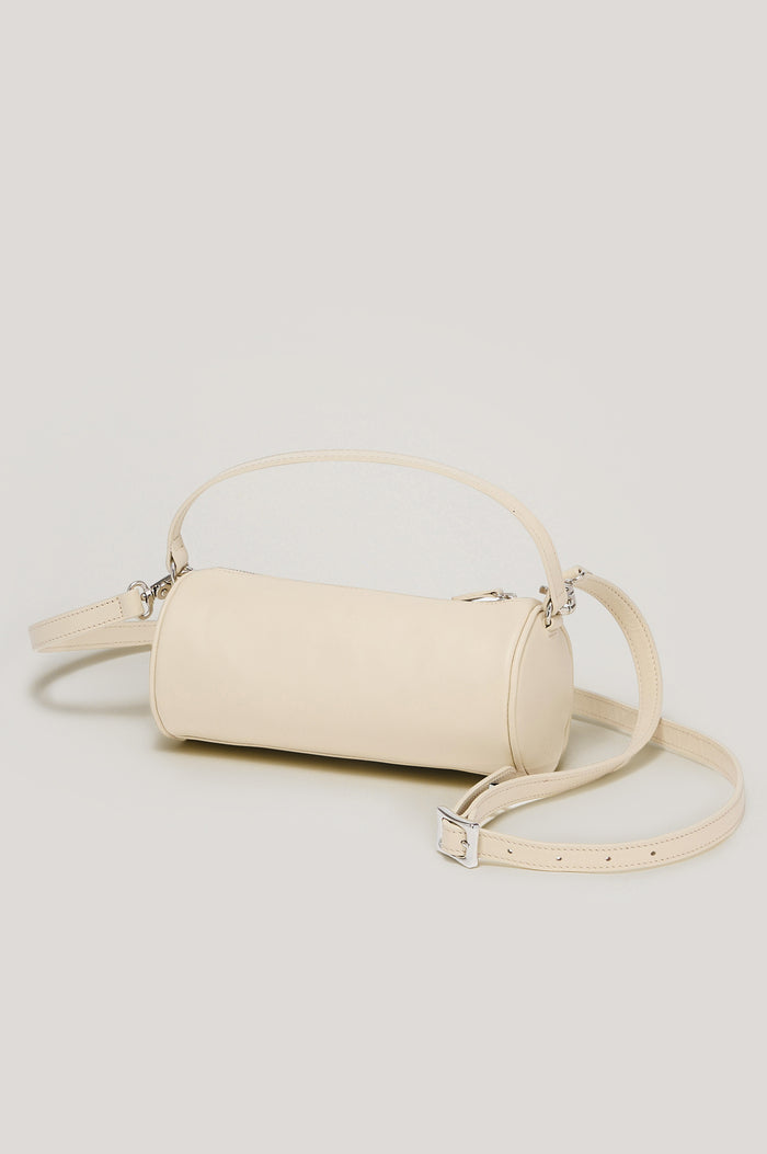 Como Mini Barrel Bag in Italian Leather With Fixed Top Strap, Removable and Adjustable Buckled Crossbody Strap, Top Zipper, Side-Embossed Logo, Branded Interior Label in Bone Colorway - Front View Featured