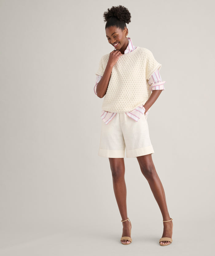 Model is wearing UNTUCKit Cotton Cap Sleeve Emily Sweater.