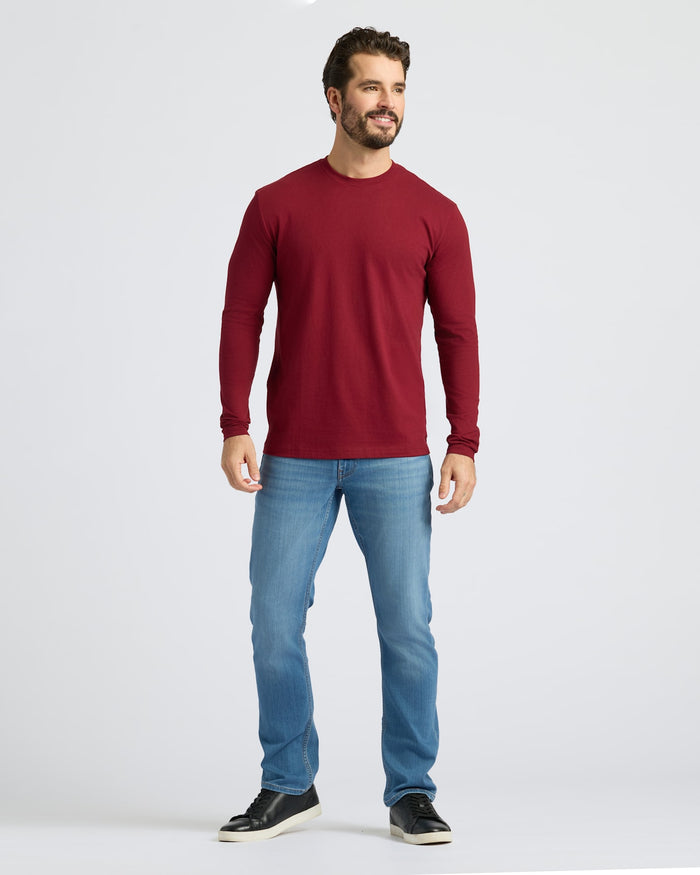 Model in Dark Maroon Classic Long Sleeve Crew Neck, light jeans, sneakers.