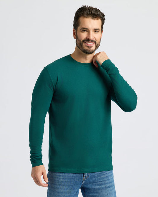 Man in Classic Long Sleeve Crew Neck, deep green, and medium-wash jeans.