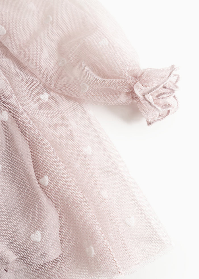 Dear bridal dress in light pink tulle with small hearts and a ruffled collar at the sleeves