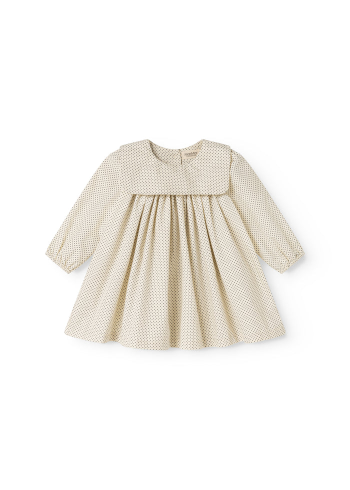 Polka-dotted baby dress with a ruched bodice and long sleeves.