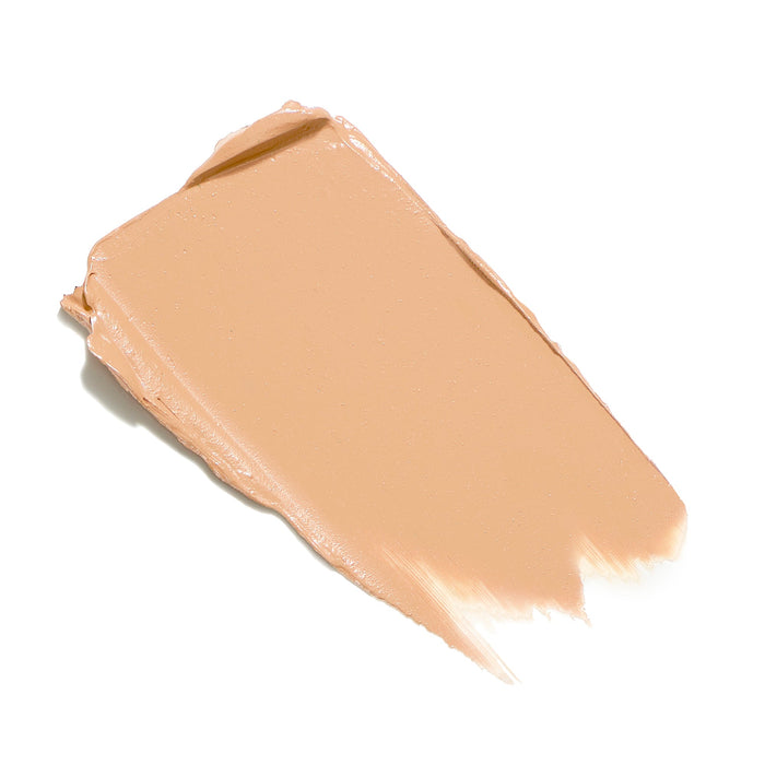 Smooth beige cream swatch of Enlighten Plus Under-Eye Concealer | Jane Iredale, showcasing its silky texture for skincare and makeup application.