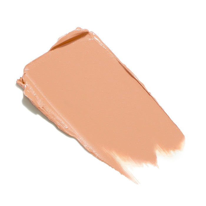 A smooth swatch of a light beige creamy concealer representing the shade of Enlighten Plus Under-Eye Concealer | Jane Iredale for skincare and beauty use.