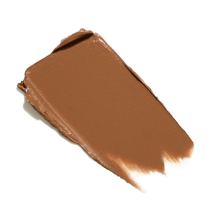 Swatch of creamy medium brown skincare concealer texture from Enlighten Plus Under-Eye Concealer | Jane Iredale, showcasing smooth application and rich pigmentation.