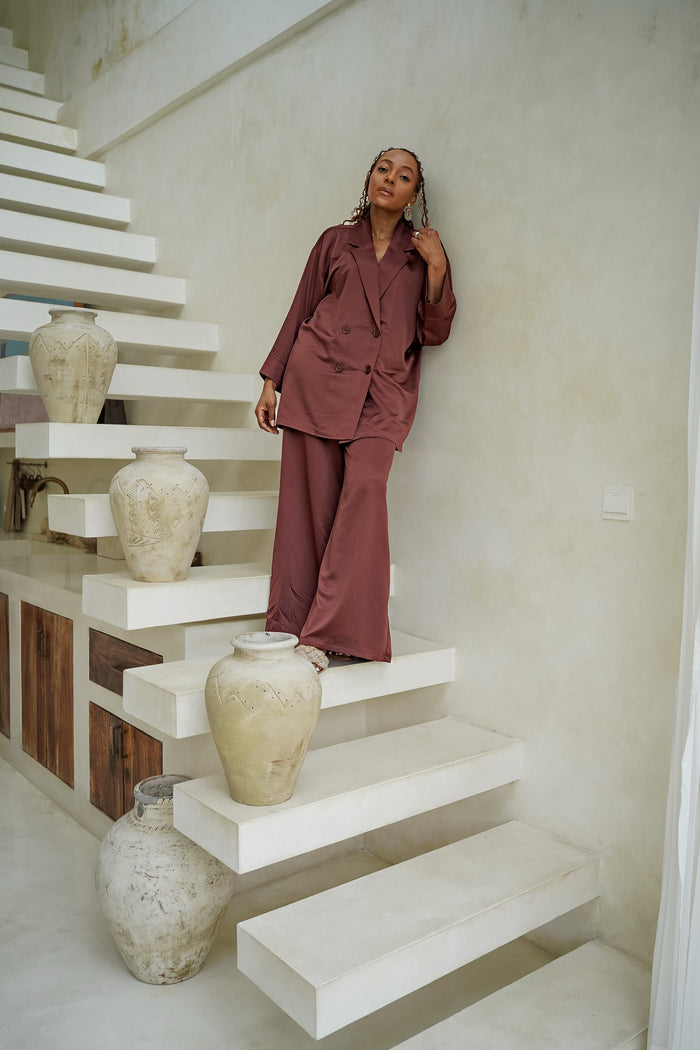 satin double-breasted suit, wine satin blazer and pants, FabroSanz luxe lounge wear, elegant wide-leg trousers South Africa, relaxed tailored suit, minimalist satin outfit, satin lounge suit for women, African designer lounge set, luxe resort fashion, modern satin co-ord set