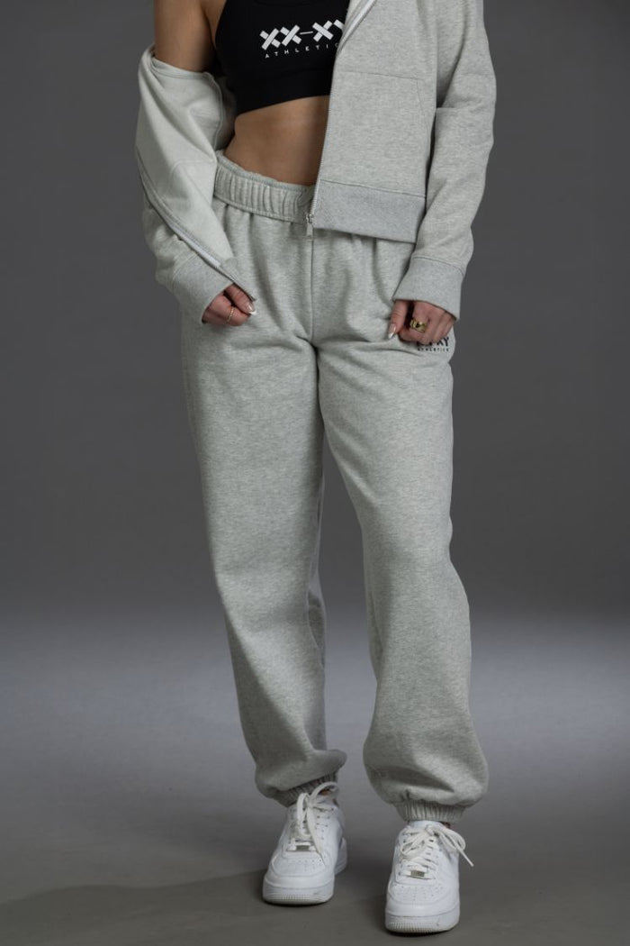 Person wearing a gray tracksuit with a black crop top on a gray background || Light Heather Gray