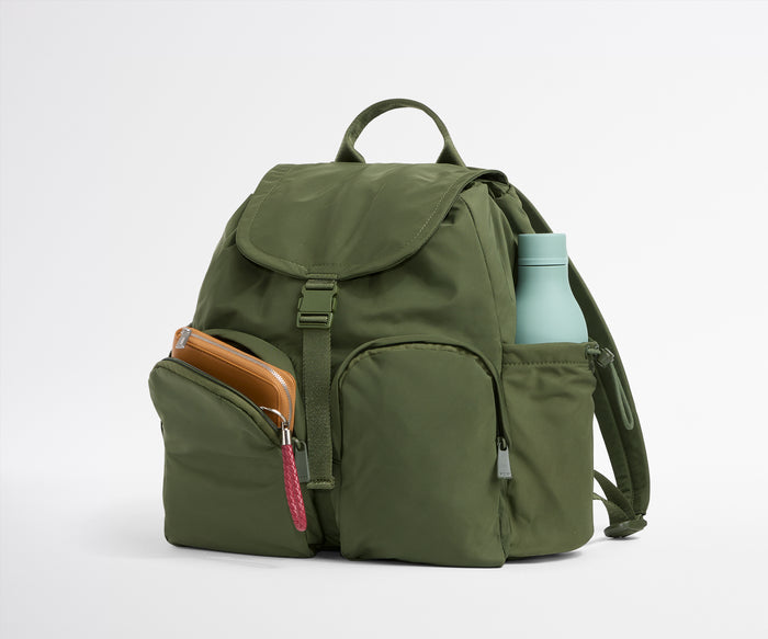 Green backpack with a water bottle on a white background
