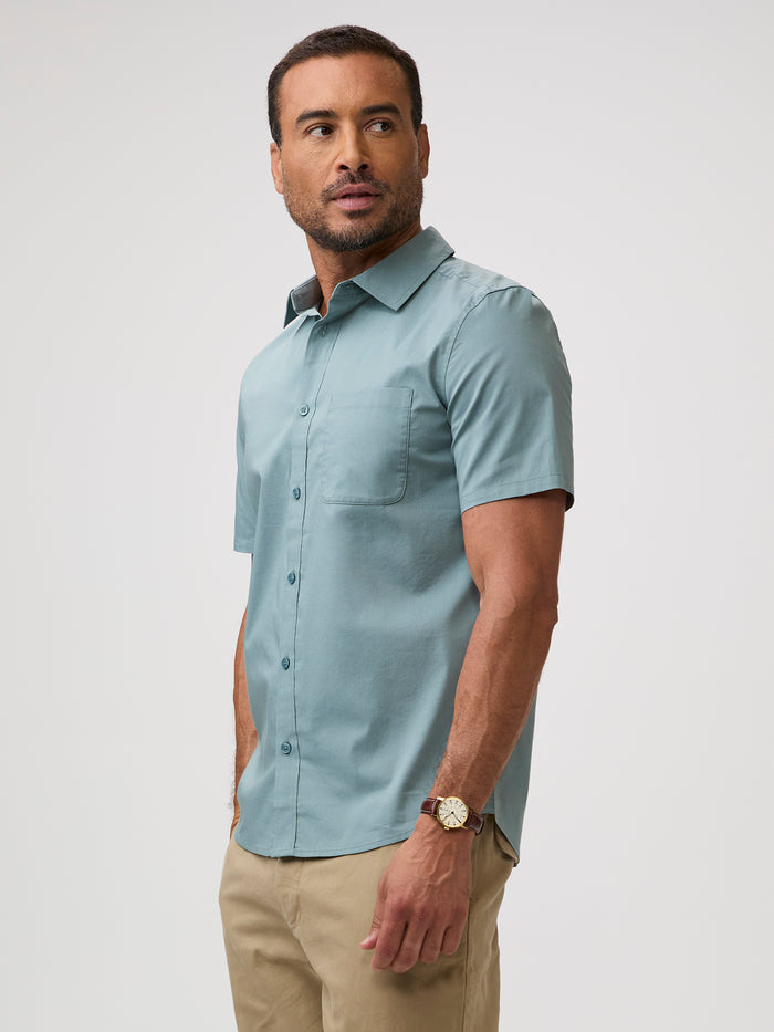 Man wearing a comfortable blue short-sleeve shirt | Stretch cotton-poly-spandex blend for mobility