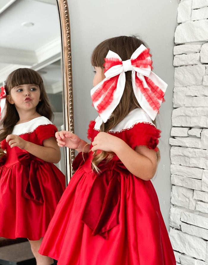 Back view of Holly Ruffle Hair Bow showcasing oversized red and white satin ribbon with festive ruffle detail.