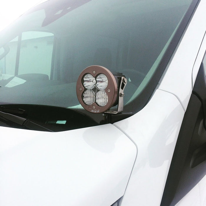 Hoodline Light Pod Mount - Transit (2013+) by Van Compass, shown installed on a truck's windshield with a close-up of mounting hardware for LED pod lights.