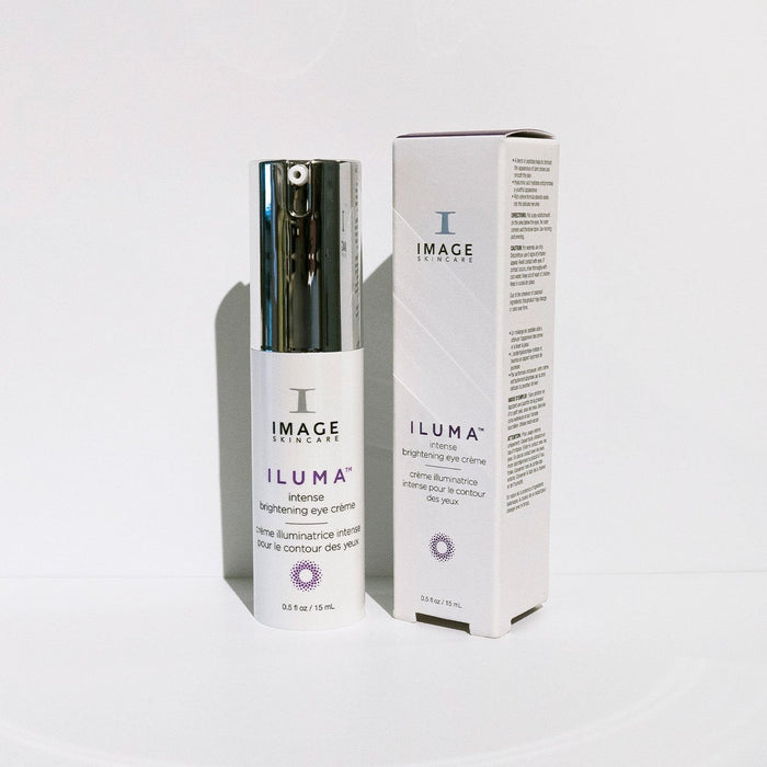 ILUMA intense brightening eye crème | IMAGE Skincare in a white bottle with a silver pump next to its matching box, both designed for skincare and brightening the eye area.