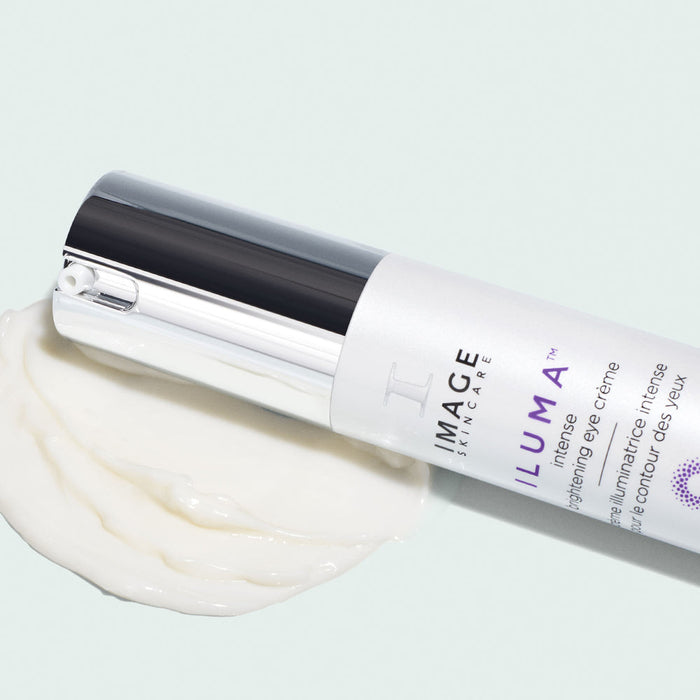 ILUMA intense brightening eye crème | IMAGE Skincare tube with creamy white eye crème on a light surface, highlighting smooth texture and skincare packaging design.