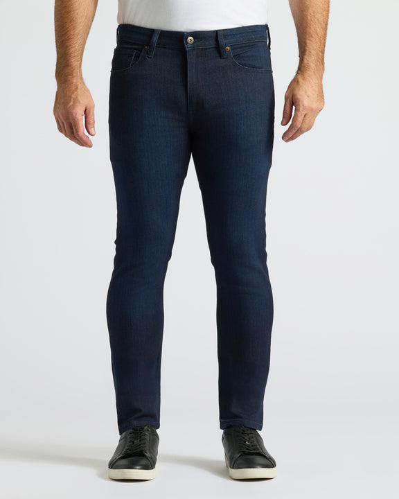Indigo Wash Slim Comfort Stretch Jeans with black sneakers.
