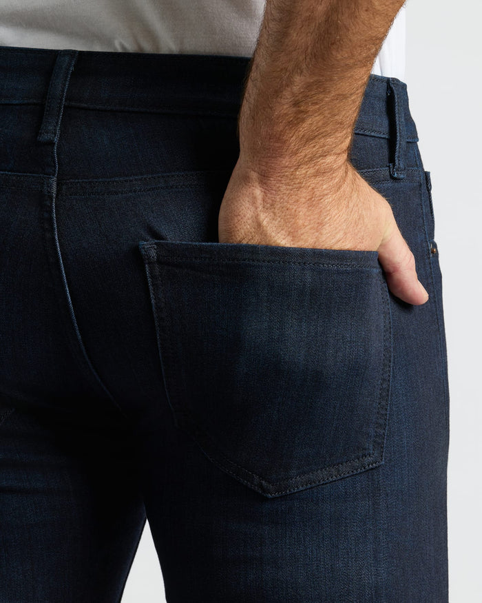 Indigo Wash Slim Comfort Stretch Jeans with hand in back pocket.