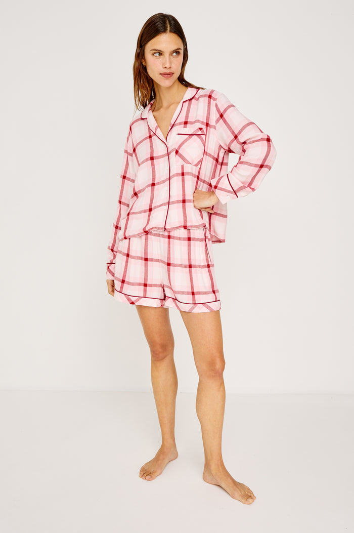 Kellen Pajama Set in Signature Rayon With Relaxed Long Sleeve Button-Up Shirt With Notched Collar and Matching High-Waisted Shorts With Adjustable Drawstring Ties in Pink Cherry Plaid Colorway - Full Body Front View Featured on Model