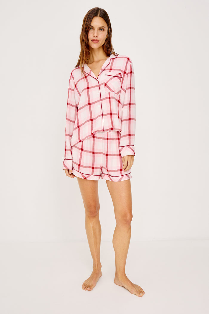 Kellen Pajama Set in Signature Rayon With Relaxed Long Sleeve Button-Up Shirt With Notched Collar and Matching High-Waisted Shorts With Adjustable Drawstring Ties in Pink Cherry Plaid Colorway - Full Body Front View Featured on Model