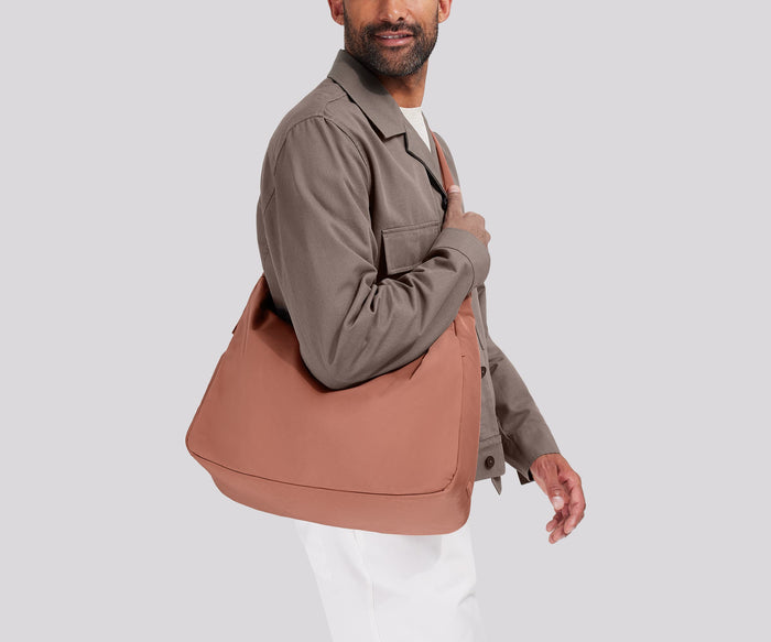 Person wearing the Large Featherlight Crossbody
// Model is 6’0”