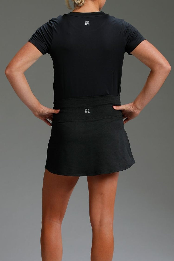 Person wearing a black athletic outfit on a gray background || Black Heather