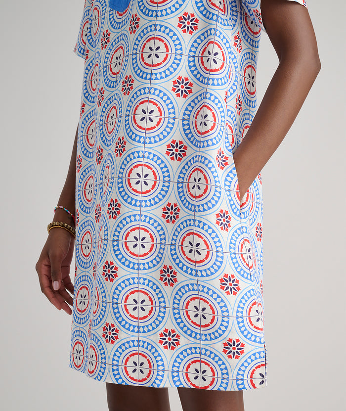 Model are wearing UNTUCKit Paola dress in printed tile blue.