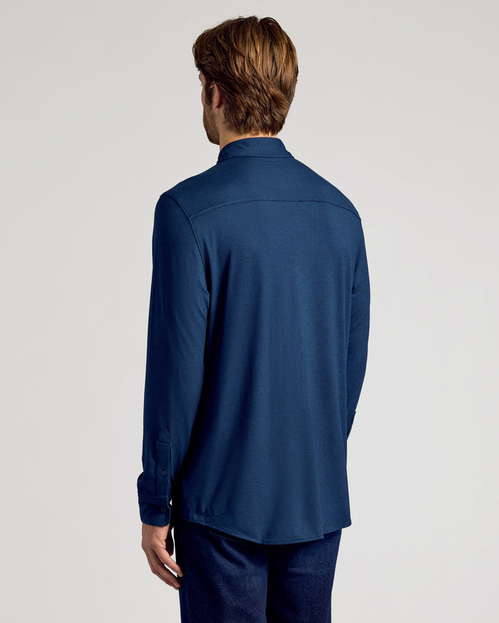 Back view of a man wearing the Long Sleeve Do-It-All Comfort Shirt.